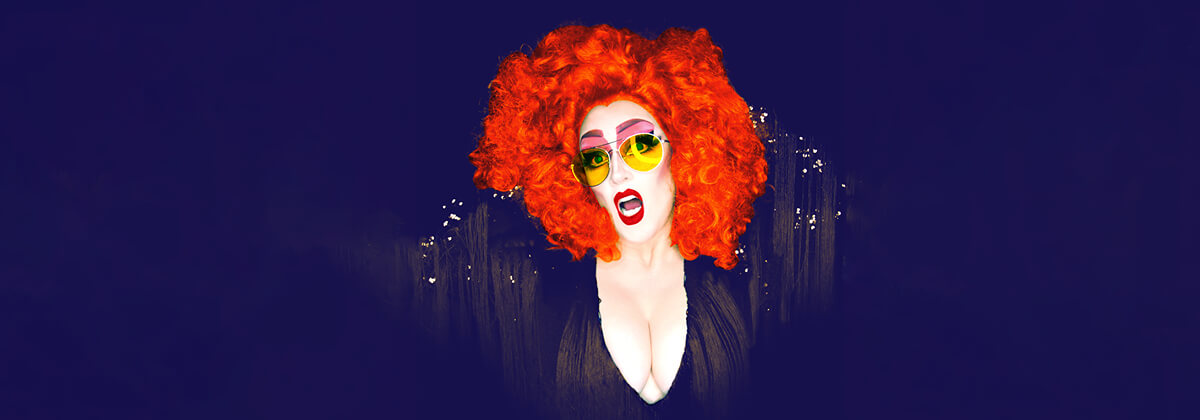 Geraldine Quinn with orange hair and yellow sunglasses