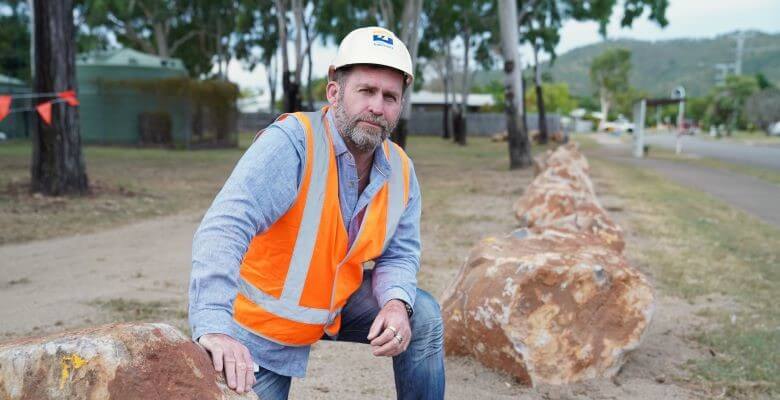 Cr Kristian Price inspecting the boulder installation at Jabiru Park.