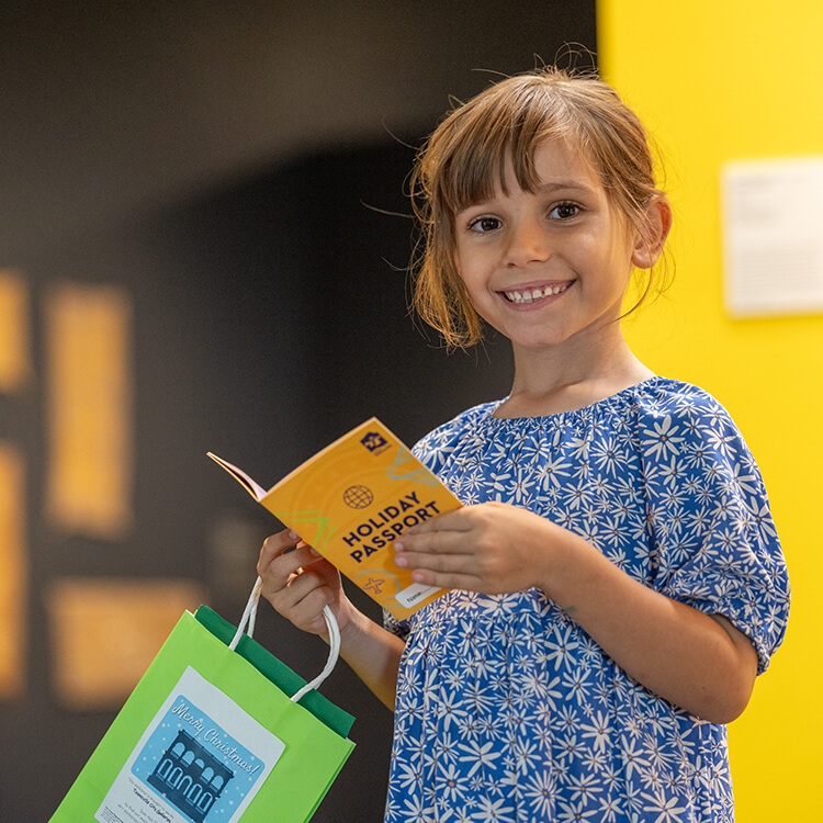 Smiling girl holding Holiday Passport