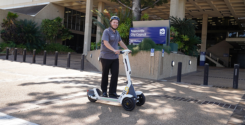 Cr Phillips test riding a new ARIO e-scooter